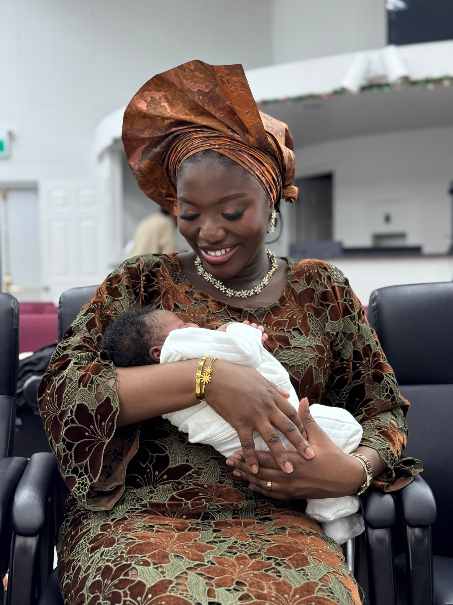 Mother holding the baby during the ceremony